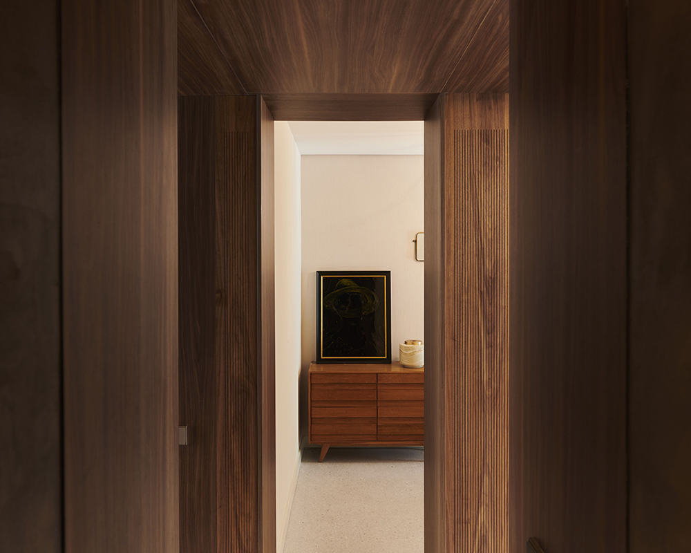 Walnut hallway with artwork and a mid-century sideboard